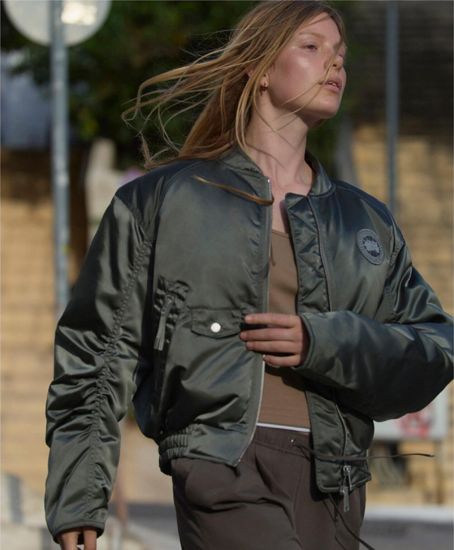 Female model in Canada Goose bomber, windswept hair