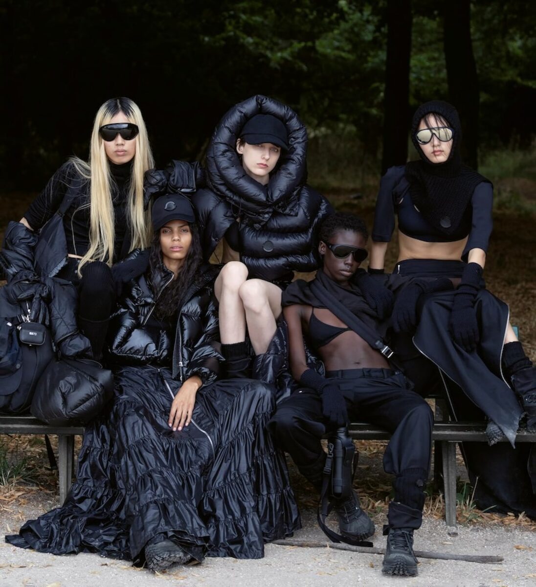 Five models seated on a park bench in Moncler AW25